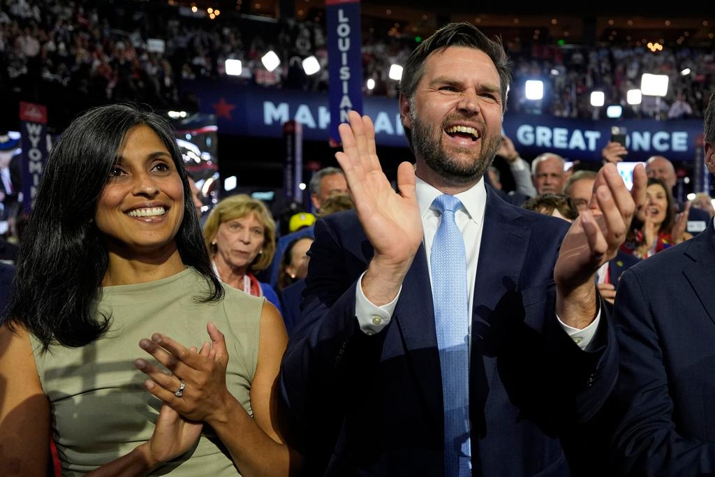 Republican vice presidential candidate Sen. JD Vance, R-Ohio, and his wife Usha Chilukuri Vance arrive on the floor during the first day of the 2024 Republican National Convention