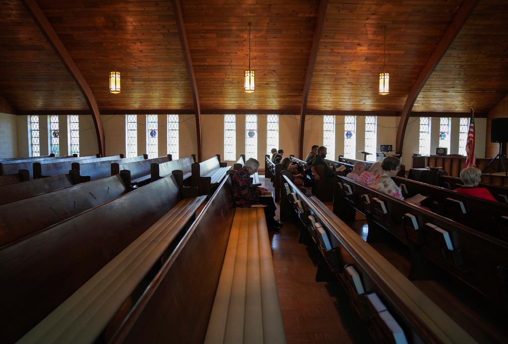  Roughly a dozen people attend pastor Ryan Burge's Sunday service at First Baptist Church in Mt. Vernon, Ill.