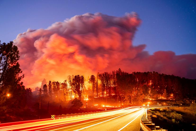 Seen in a long exposure photograph, the Park Fire burns along Highway 32 in the Forest Ranch community of Butte County, Calif., on Thursday, July 25, 2024. 