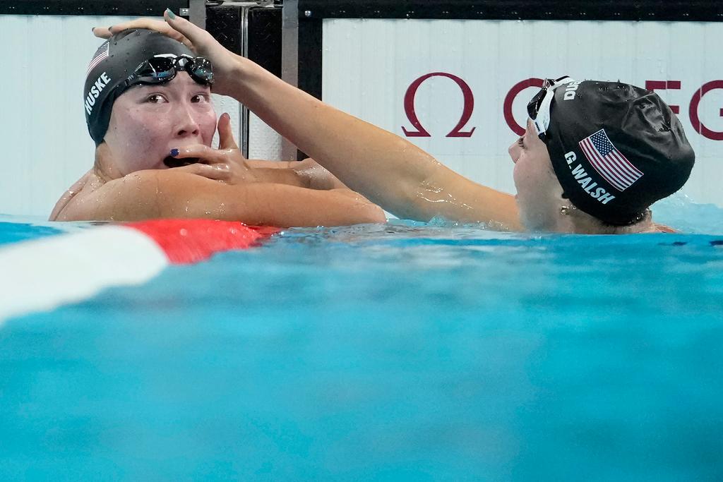 Torri Huske, left, of the United States, reacts after winning the women's 100-meter butterfly final with teammate Gretchen Walsh at the 2024 Summer Olympics