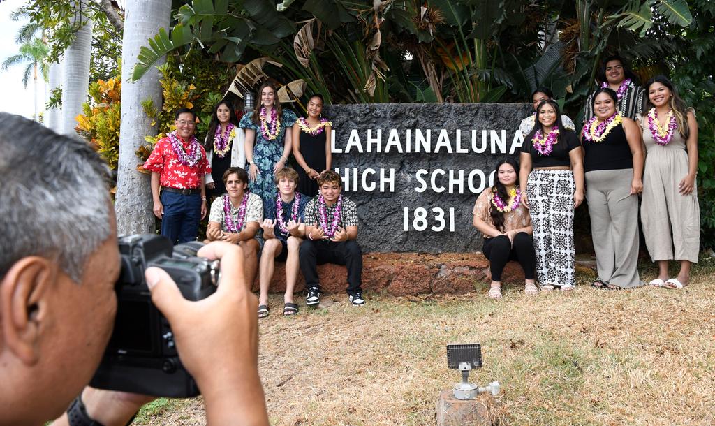 Lahainaluna High School 2024 graduates pose with Downtown Athletic Club of Hawaii President Keith Amemiya, left, after a scholarship presentation Wednesday, July 31, 2024, in Lahaina, Hawaii.