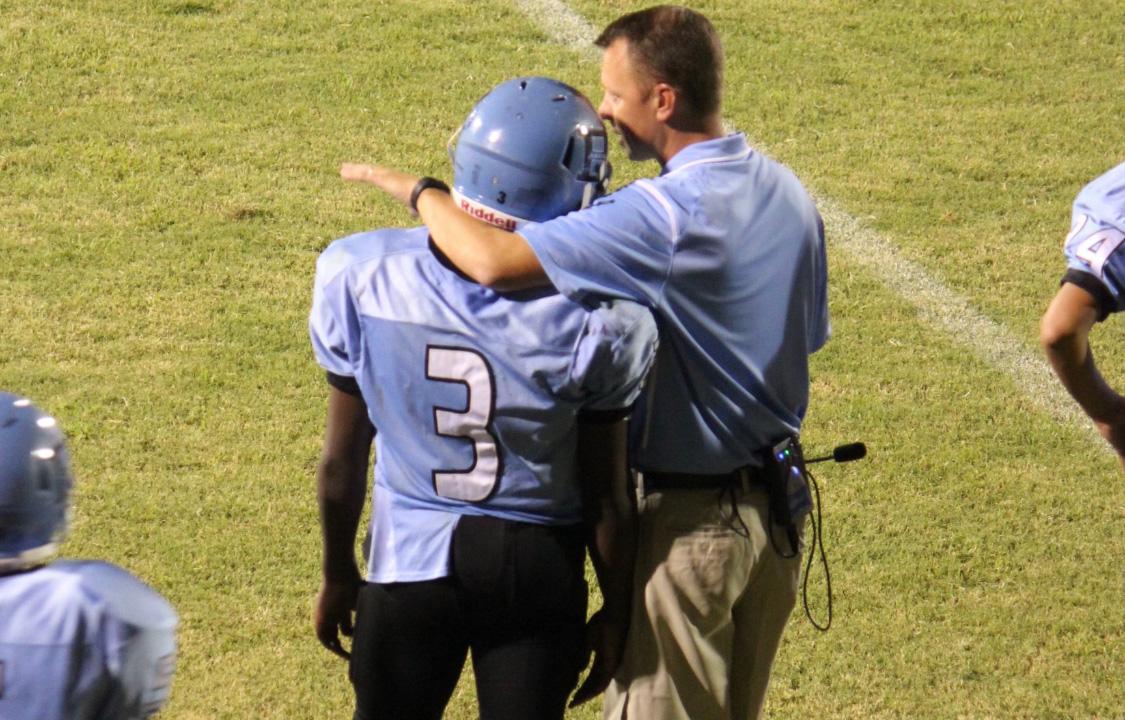 Coach with a football player