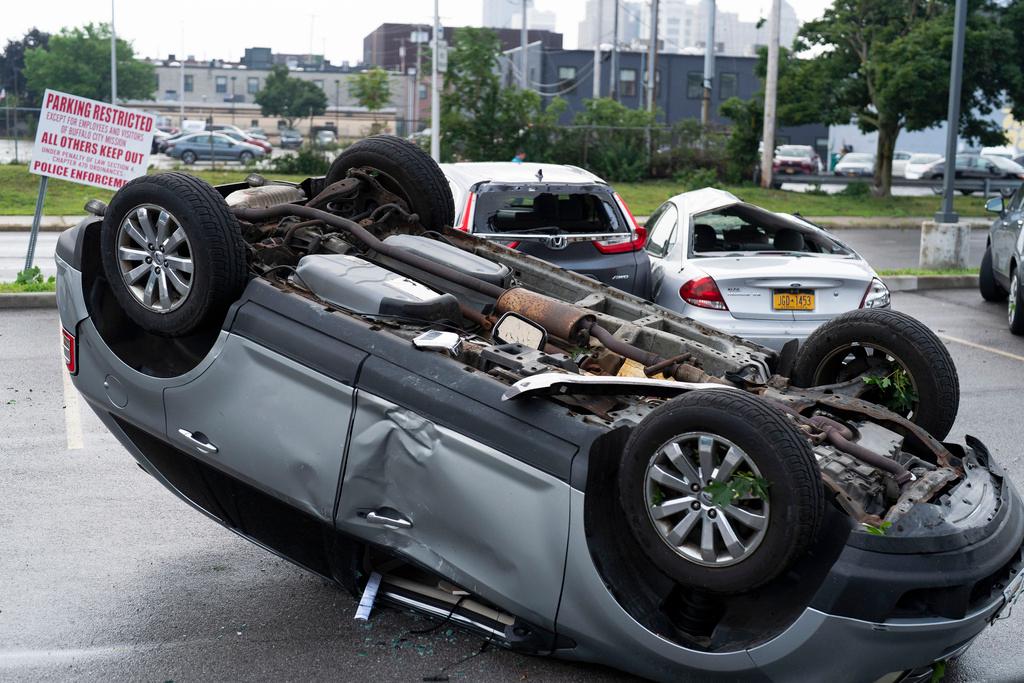 Flipped car sits in the parking lot of the Buffalo City Mission after a sudden storm hit 