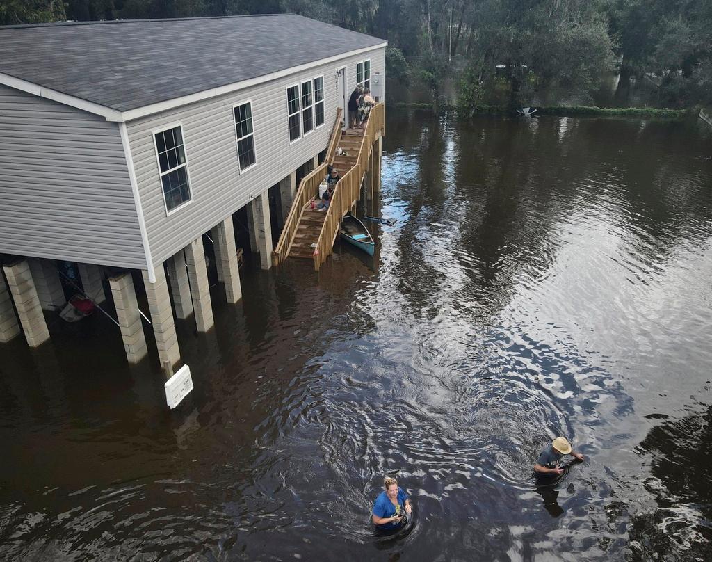 A neighborhood a half-mile from the Alafia River is inundated with waist-high water after rainfall from Tropical Storm Debby