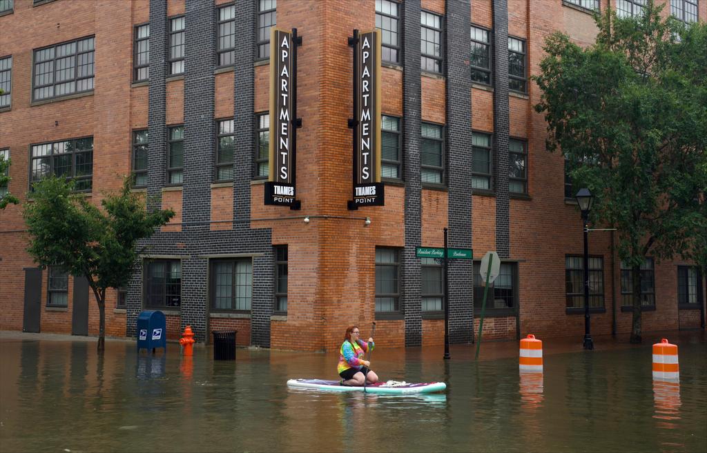 Lily Gensler goes for a paddle in Fells Point in Baltimore as the remnants of Hurricane Debby pass through 