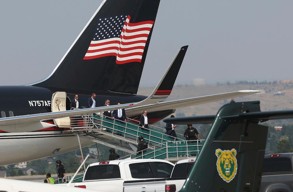 Members of former President Donald Trump's team disembark from his Boeing 757 after arriving at the Billings Logan International Airport in Billings, Mont.