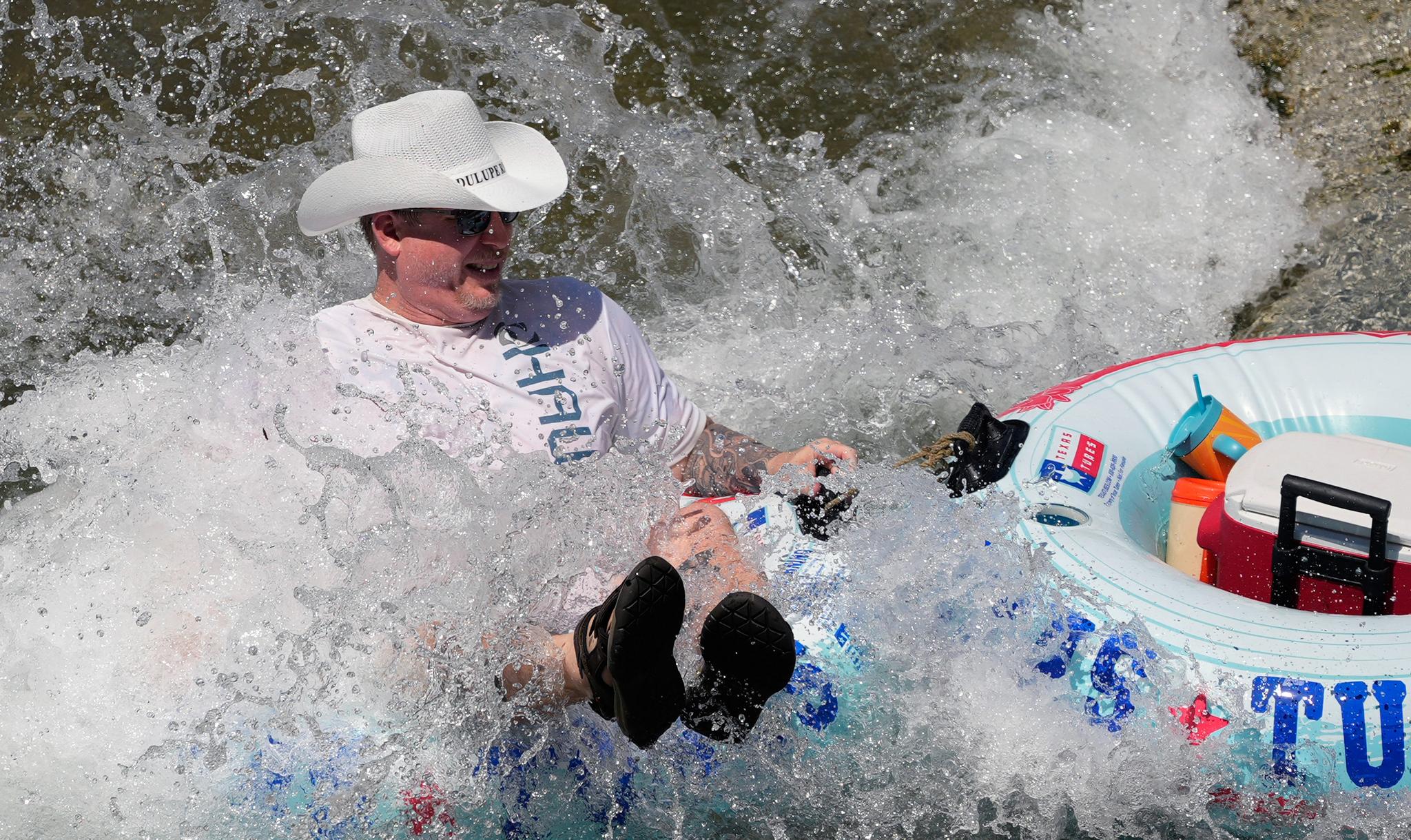 Man with cowboy hat in water