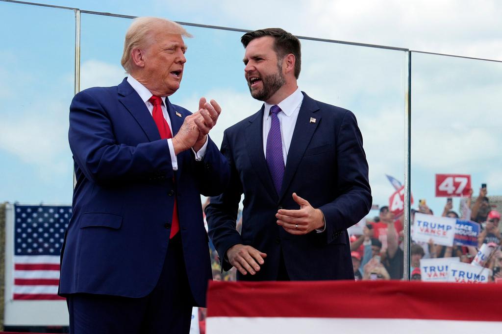 Republican presidential nominee former President Donald Trump and Republican vice presidential nominee Sen. JD Vance, R-Ohio, stand on stage at a campaign rally at North Carolina Aviation Museum