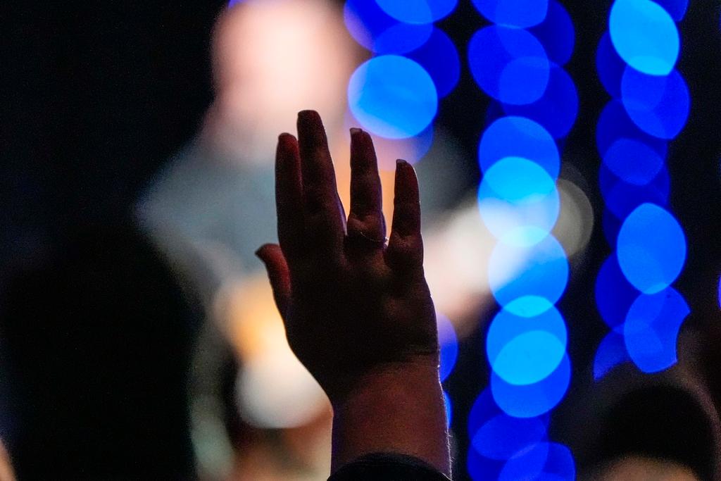 Church members pray for community and worship during service at Bethlehem Church in Bethlehem, Ga.