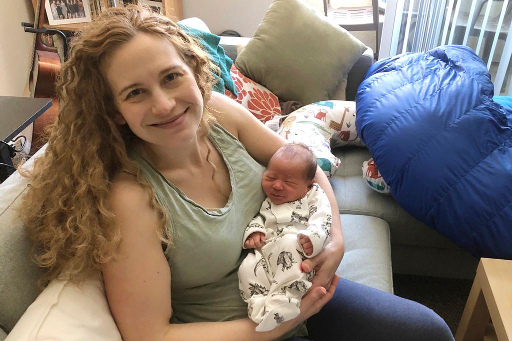 In this photo provided by Liz Chrastil, a neuroscientist with the University of California, Irvine, she her holds her newborn son in May 2020.