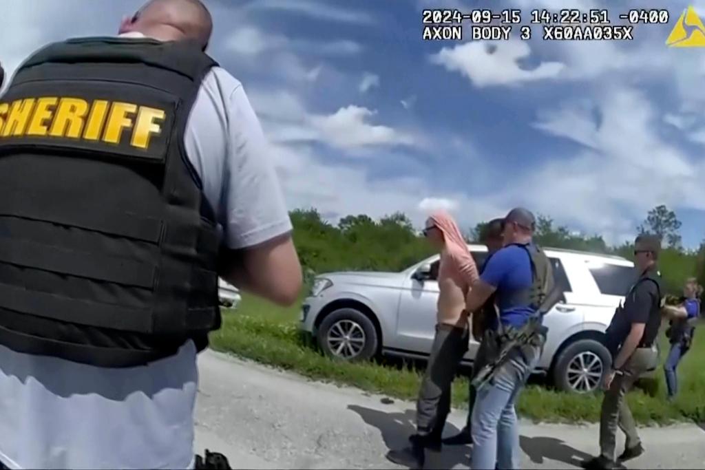 Image taken from police body camera video and released by the Martin County, Fla., Sheriff’s Office, law enforcement officers arrest Ryan Routh