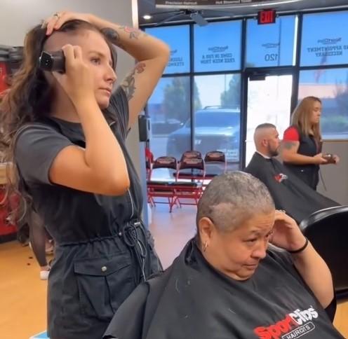 Kayla Gray, a hairdresser at a Sport Clips Salon in Caldwell, Idaho, shaves her own head in support of a client battling cancer