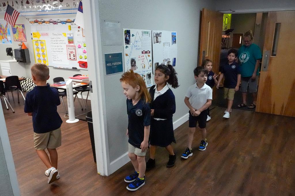 First grade students return to the classroom after a chapel service at the Winter Garden Christian Academy