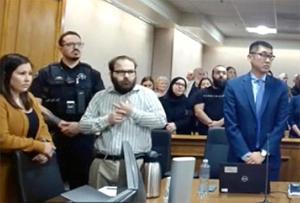 In this image taken from video provided by the Colorado Judicial Branch, Ahmad Alissa, third from left, stands for the verdict in his trial for the 2021 Colorado supermarket shootings, Monday, Sept 23, 2024, in Boulder, Colo.