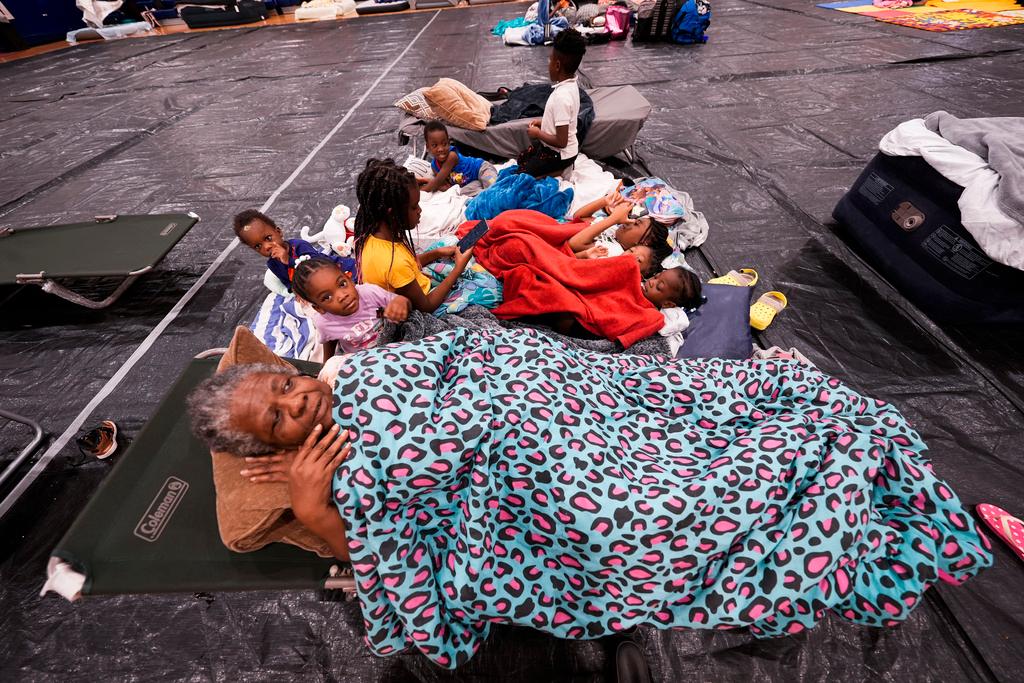 Vera Kelly, of Tallahassee, lies on a cot after evacuating to a hurricane shelter with her grandchildren and great grandchildren, at Fairview Middle School, ahead of Hurricane Helene, expected to make landfall here today, in Leon County, Fla.,