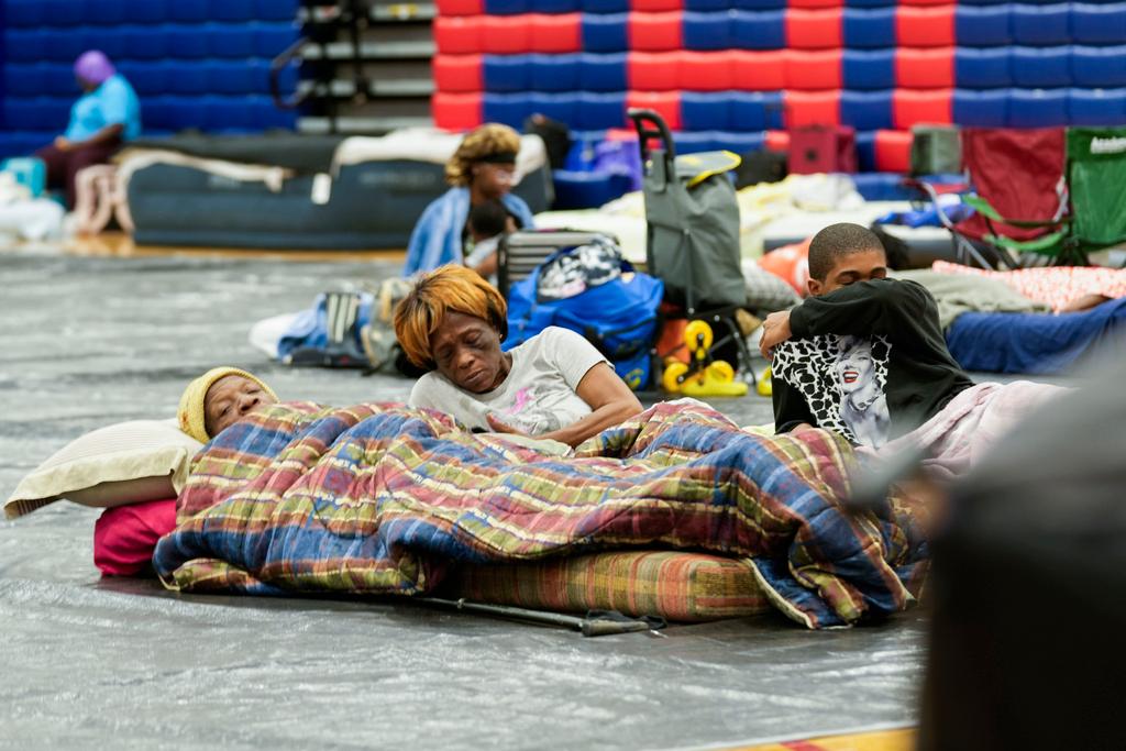 Bobby Joe Edwards, Sr., and his wife Lillie Edwards, of Walkalla, Fla., and their grandson Tavarrious Dixon, rest inside a hurricane evacuation shelter ahead of Hurricane Helene