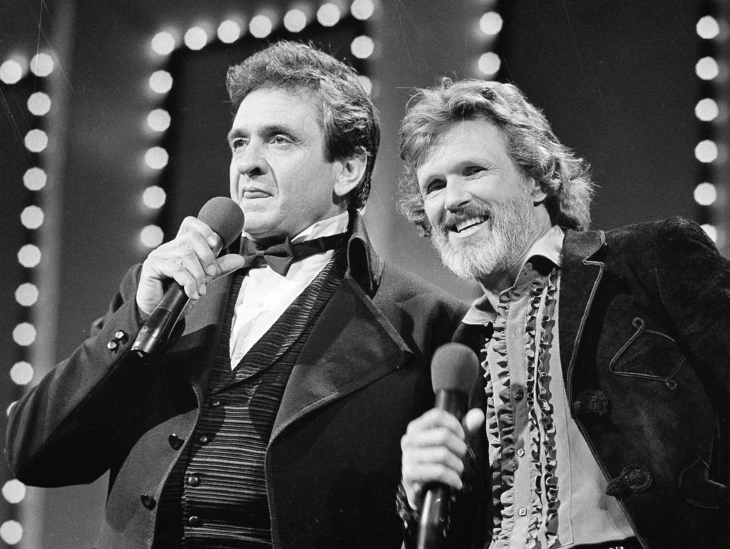 Country stars Johnny Cash, left and Kris Kristofferson sing during the Country Music Awards in Nashville, Tenn., Oct. 1983.