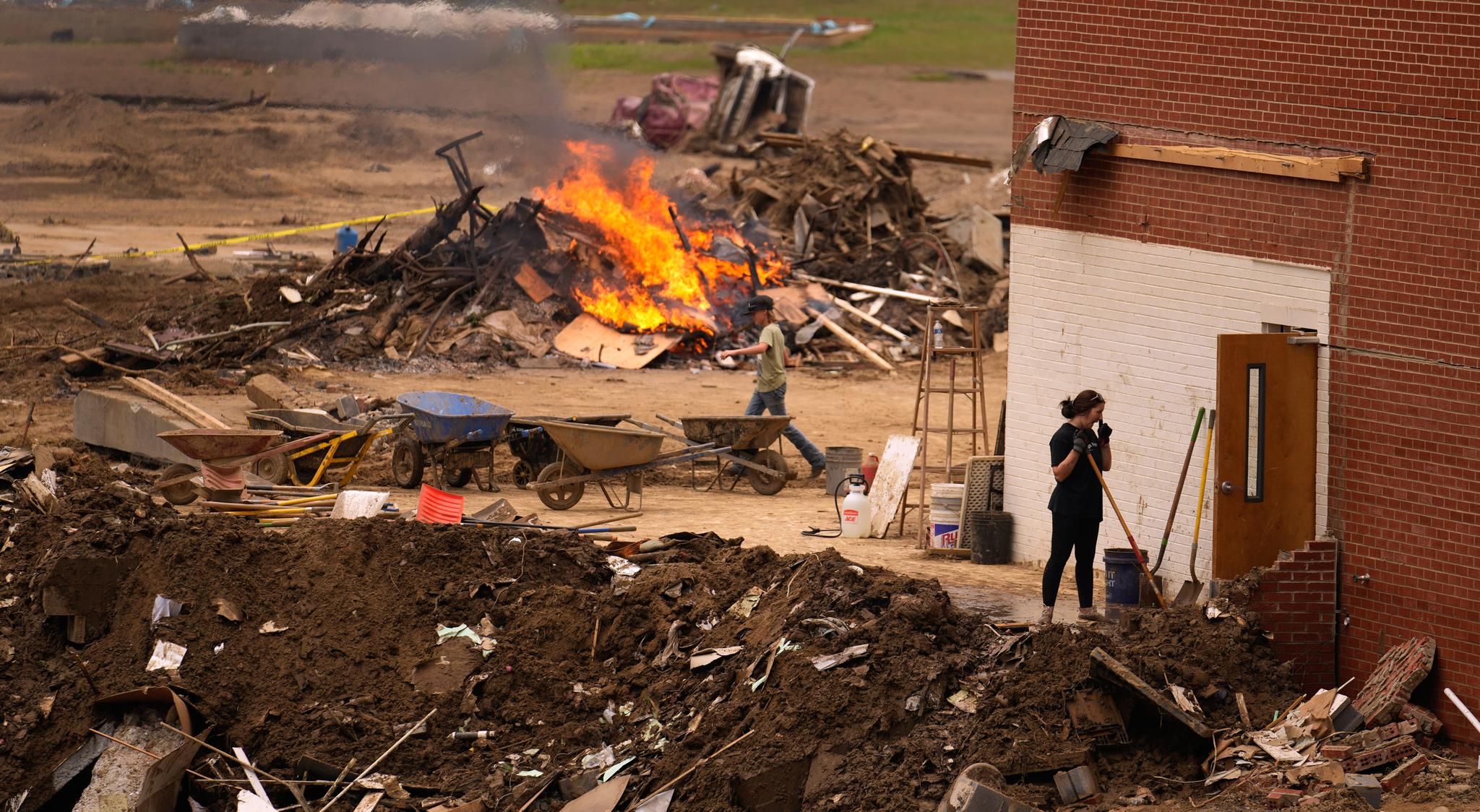 Fire and people cleaning up 