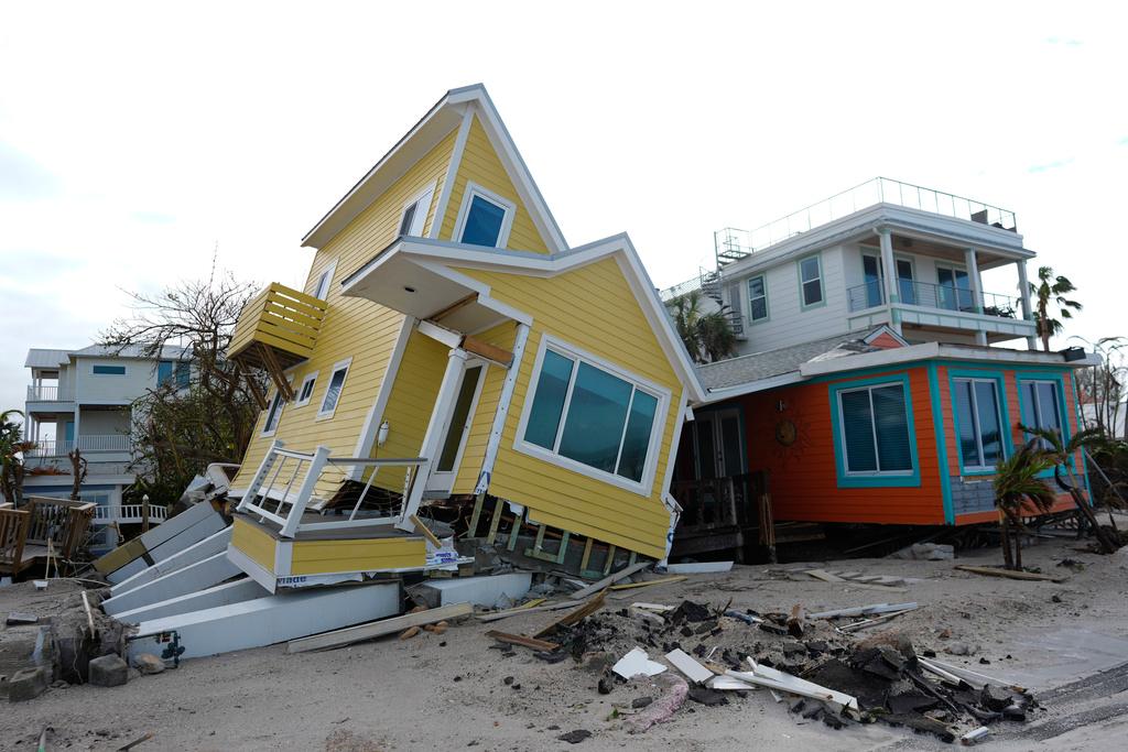 A house lies toppled off its stilts after the passage of Hurricane Milton, in Bradenton Beach on Anna Maria Island, Fla.