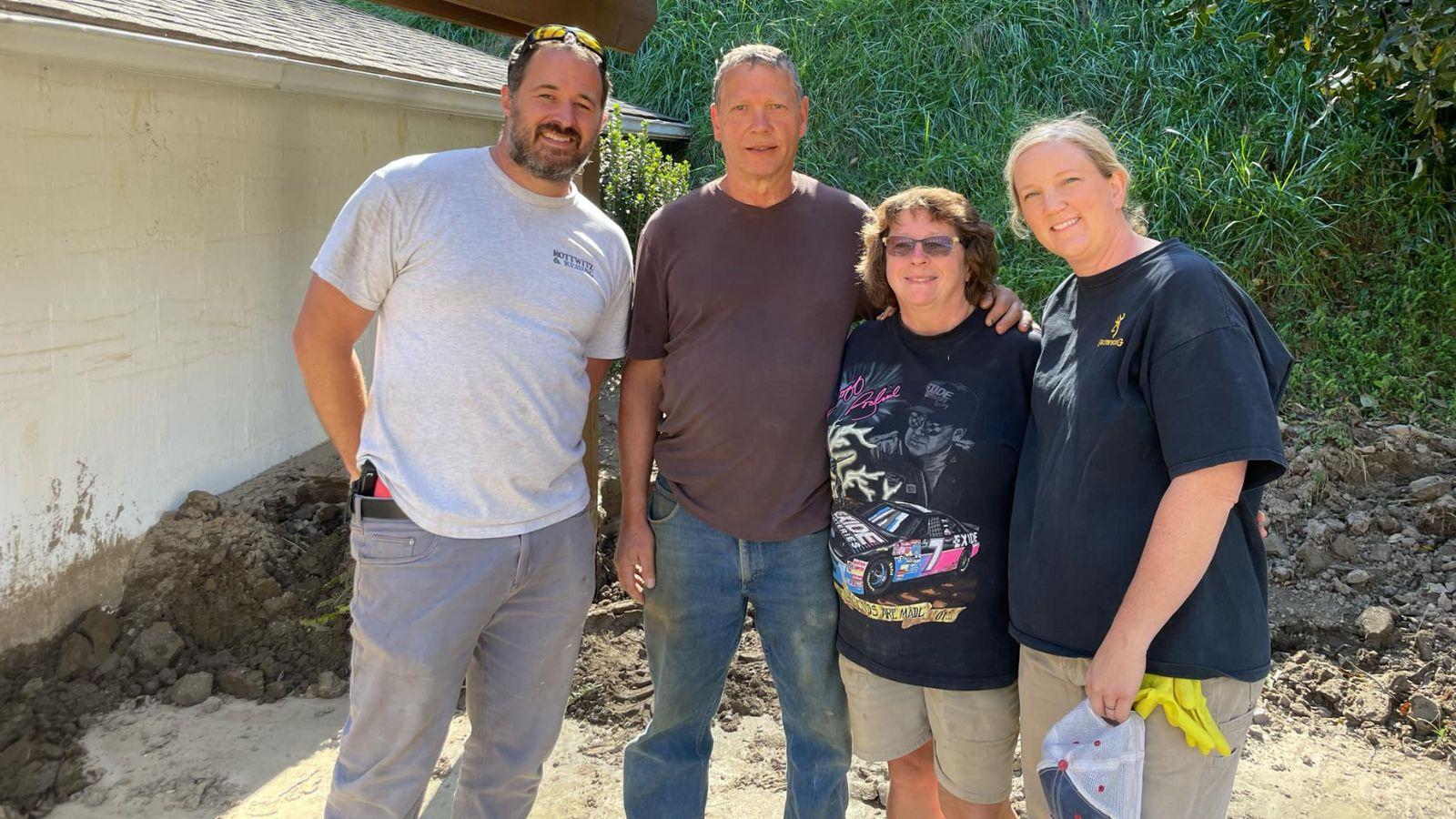 Aaron Skeesick, far left, and Marinda Skeesick, far right, pose for a picture with a couple they assisted in Green Mountain, NC. 