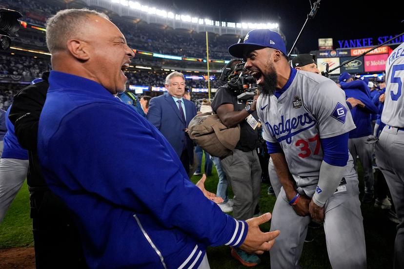 Los Angeles Dodgers manager Dave Roberts and Teoscar Hernández celebrate their win against the New York Yankees in Game 5 to win the baseball World Series, Wednesday, Oct. 30, 2024, in New York.