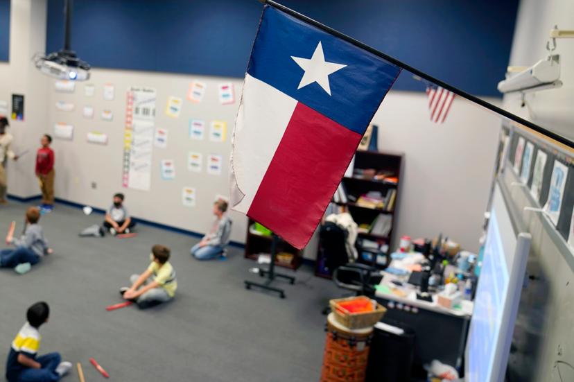 FILE - A Texas flag is displayed in an elementary school in Murphy, Texas, Thursday, Dec. 3, 2020.