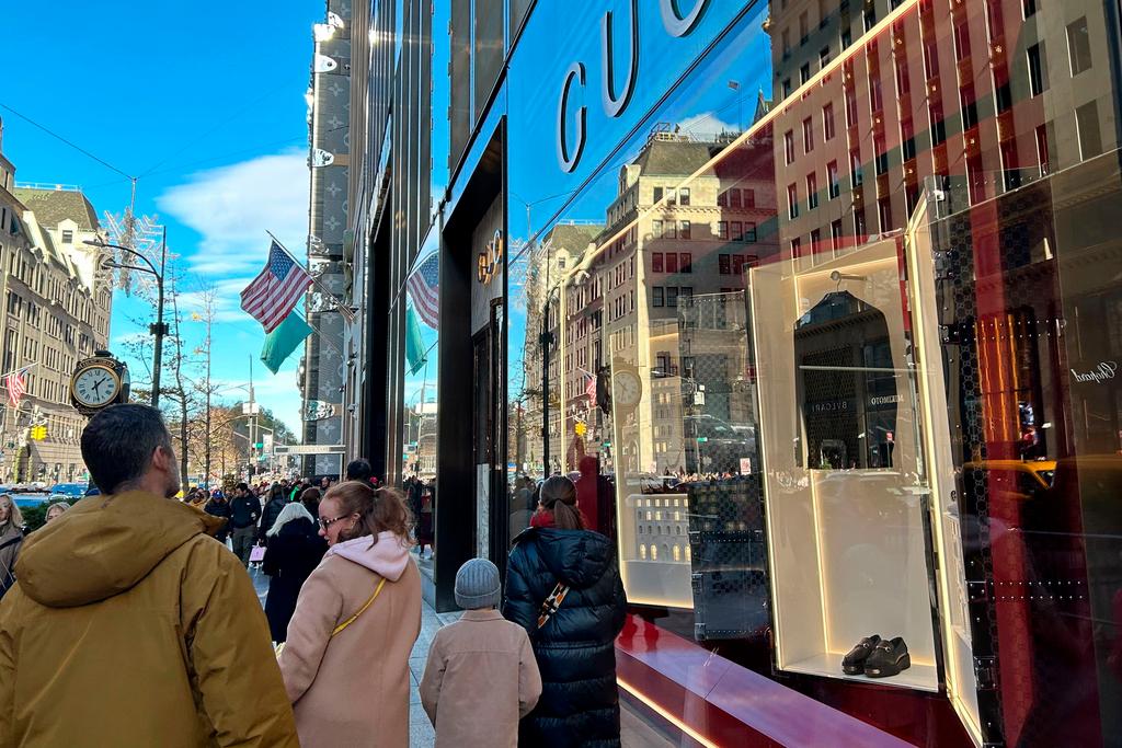 People walk past stores on Fifth Ave. on Sunday, Nov. 24, 2024, in New York.