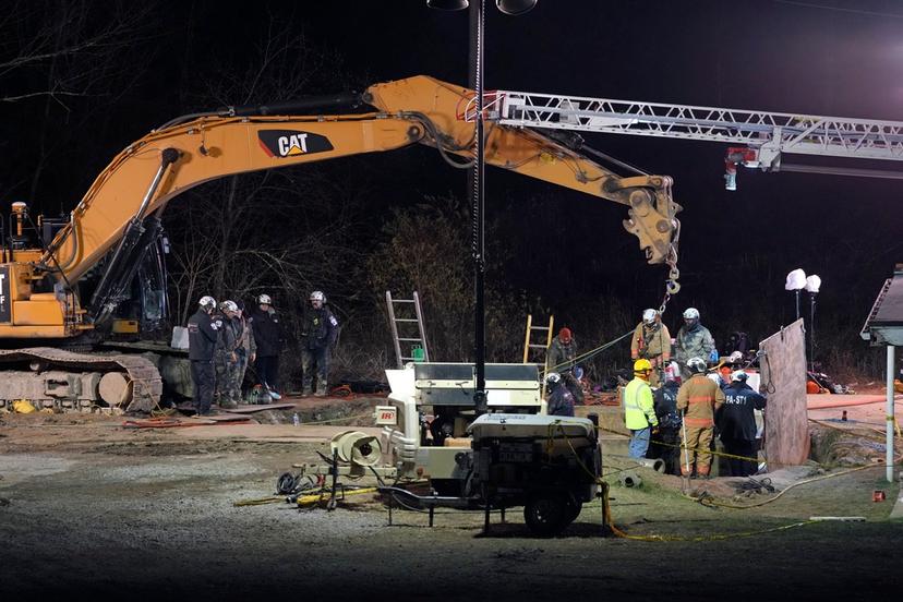 Rescue workers search through the night in a sinkhole for Elizabeth Pollard, who disappeared while looking for her cat, in Marguerite, Pa.