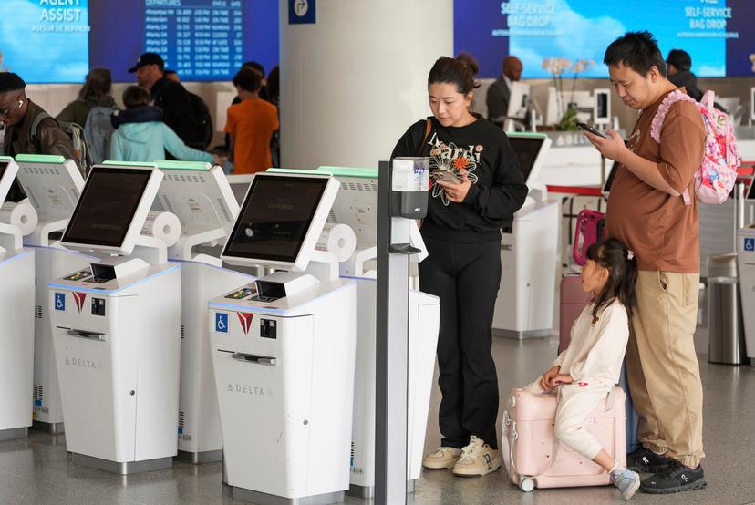 Travelers self-check at Los Angeles International Airport