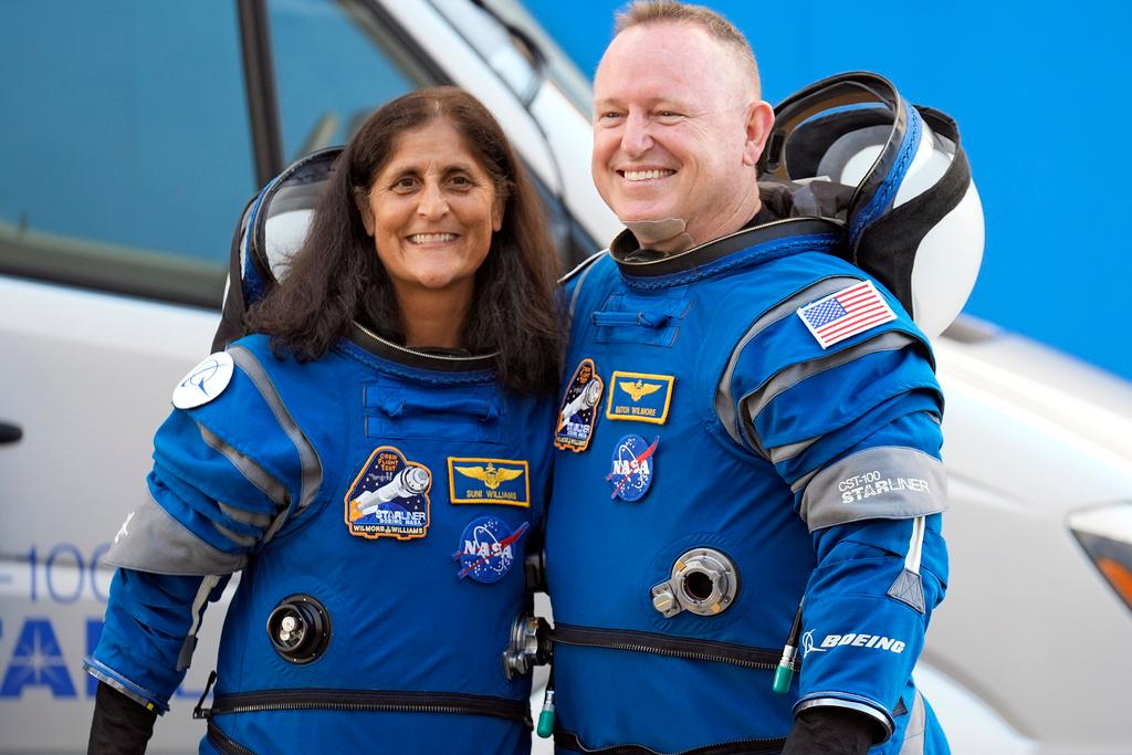 NASA astronauts Suni Williams, left, and Butch Wilmore stand together for a photo enroute to the launch pad at Space Launch Complex 