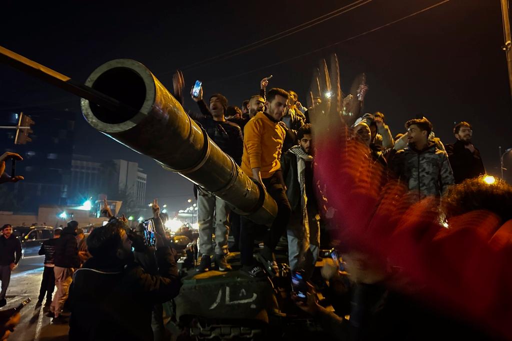 Syrians celebrate the arrival of opposition fighters in Damascus, Syria