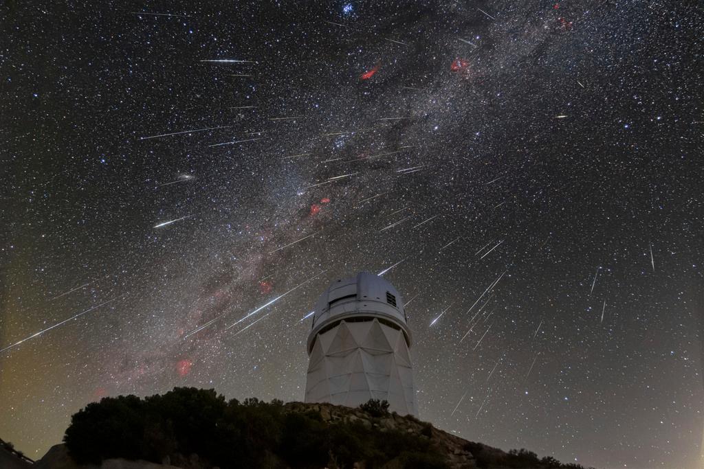 Meteors from the Geminid meteor shower streak across the sky at Kitt Peak National Observatory