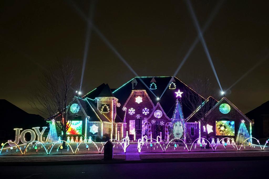 An elaborate holiday light display featuring music and imagery from the movie "Wicked" lights up the home of Elisabeth and Mark Miranda in Edmond, Okla.,, on Dec. 8, 2024.