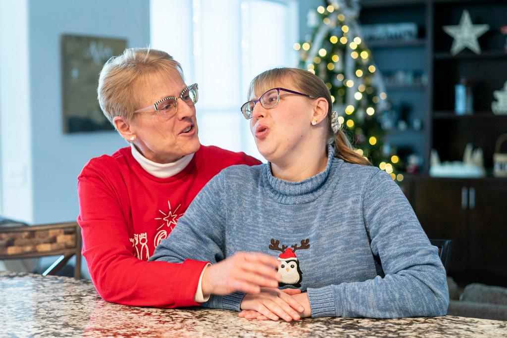 Kathleen Krueger and her daughter, Megan, 28, sit together at their home in Racine, Wis.