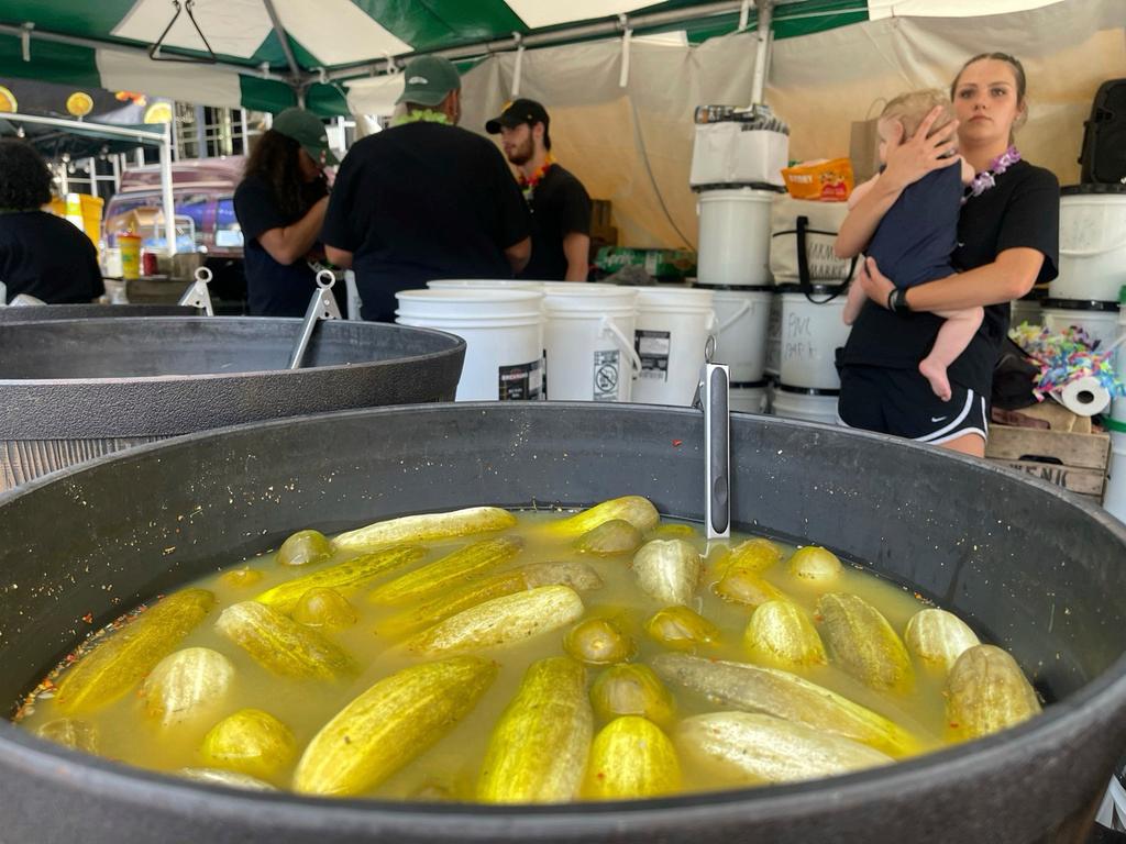 Sour pickles sit in a bucket of brine at a stall at Picklesburgh, Pittsburgh, Pa. - The festival, held just off the city's Market Square each year, brings pickle lovers and permutations of pickles together. 