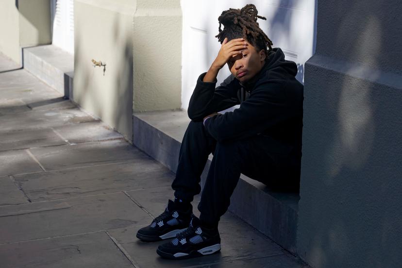 Trevant Hayes, 20, sits in the French Quarter after the death of his friend, Nikyra Dedeaux, 18, after a pickup truck crashed into pedestrians on Bourbon Street 