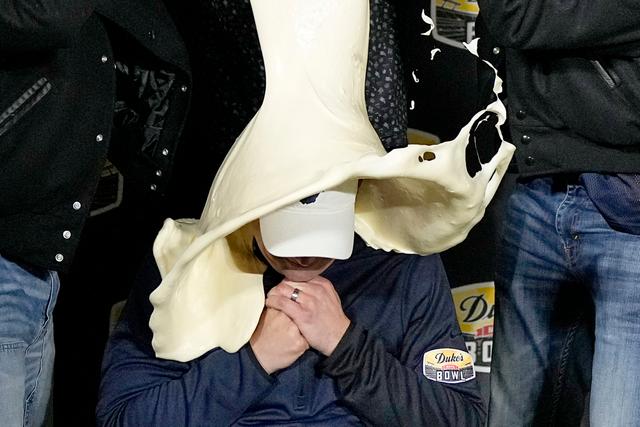 West Virginia head coach Neal Brown is dunked with mayonnaise after the team's win against North Carolina in an NCAA college football game at the Duke's Mayo Bowl 