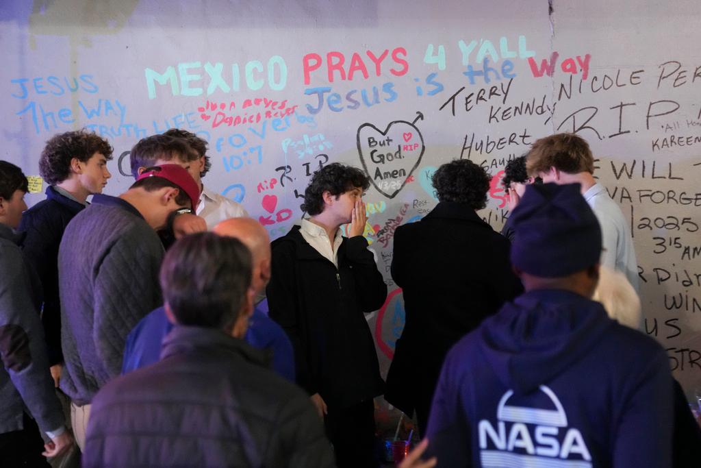 Friends of Kareem Badawi, a victim of the deadly truck attack on New Year's Day in New Orleans, pray at a memorial for victims after attending his funeral