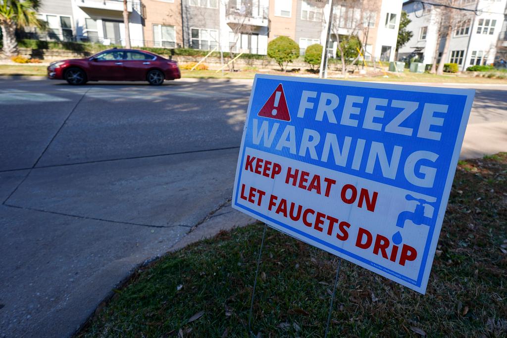 Freeze warning sign stands outside of an apartment complex ahead of a winter storm expected to hit the North Texas region