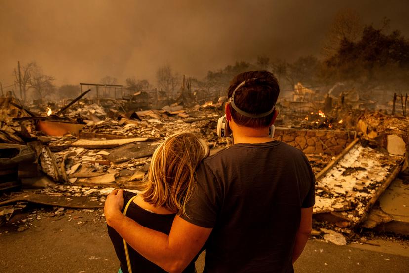 Megan Mantia, left, and her boyfriend Thomas, only first game given, return to Mantia's fire-damaged home after the Eaton Fire swept through Altadena, Calif.