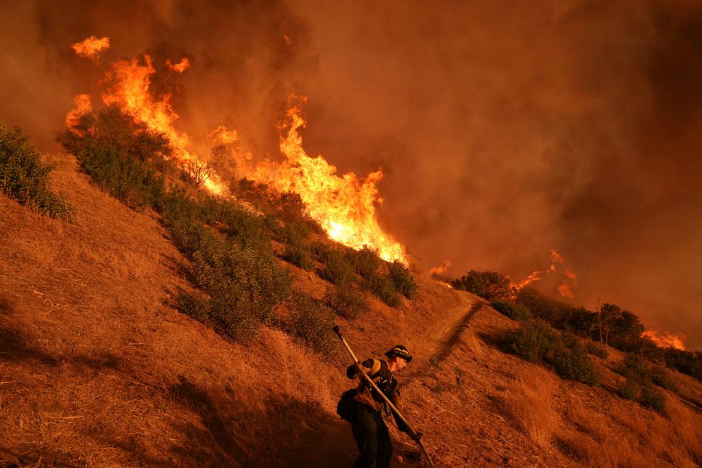 Firefighter battles the Palisades Fire in Mandeville Canyon