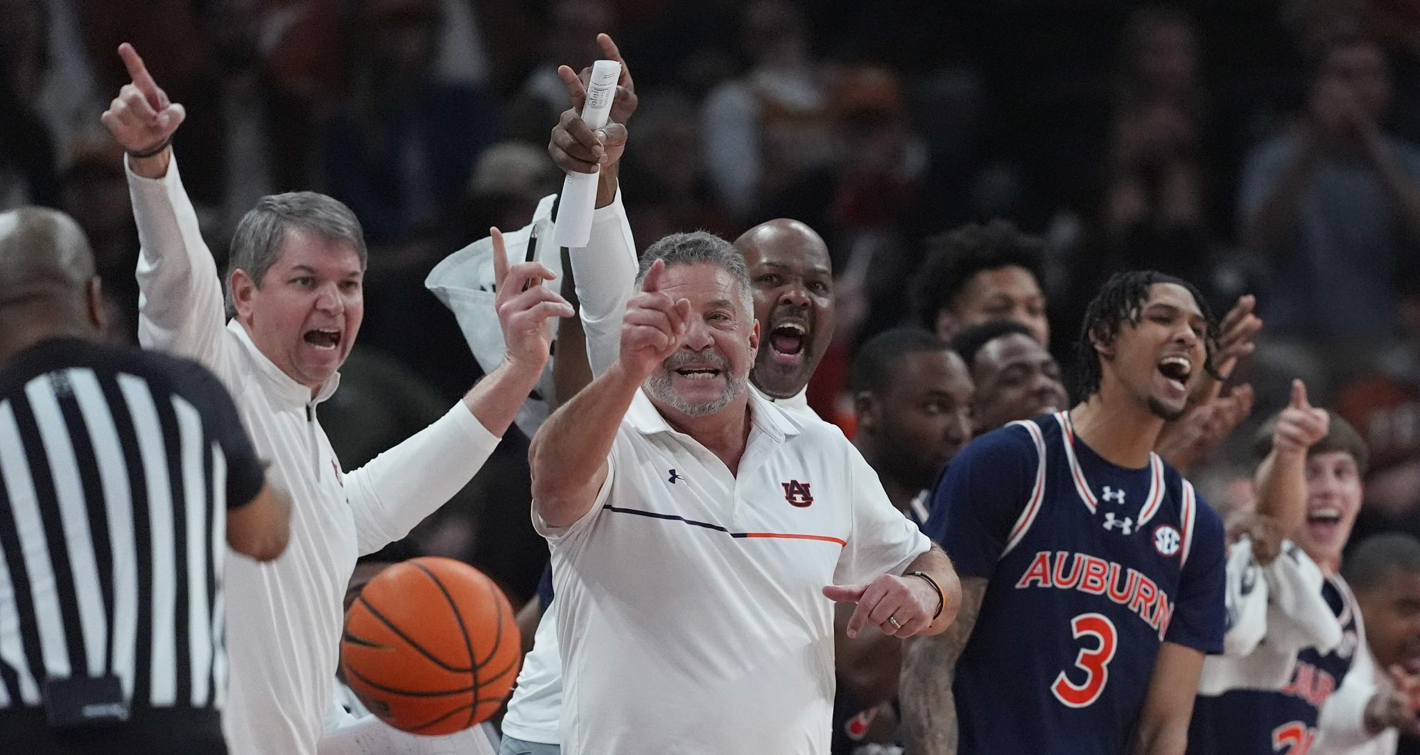 Referree, coaches and players yelling at a basketball game on the sidelines