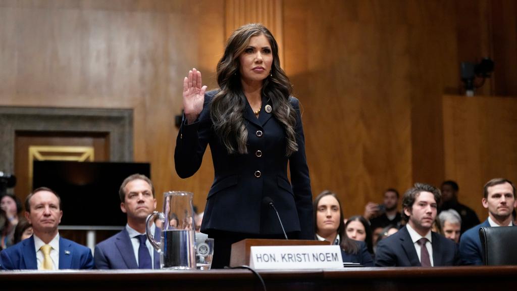 South Dakota Gov. Kristi Noem, President-elect Donald Trump's nominee to be Secretary of Homeland Security, is sworn in before the Senate Homeland Security and Governmental Affairs Committee for her confirmation hearing