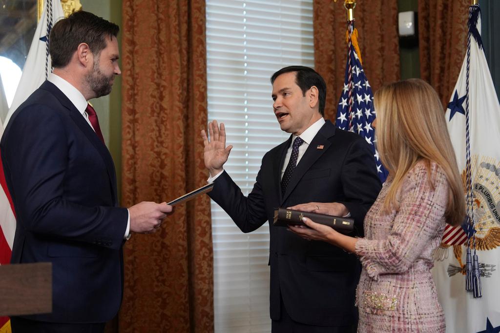 Secretary of State Marco Rubio is sworn by Vice President JD Vance in the Vice Presidential Ceremonial Office in the Eisenhower Executive Office Building on the White House campus in Washington, as his wife, Jeanette Rubio, looks on. 