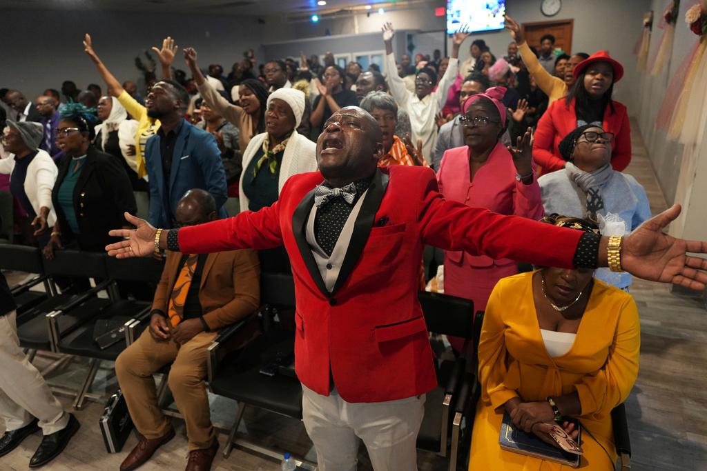 Jean-Michel Gisnel cries out while praying with other congregants at the First Haitian Evangelical Church of Springfield