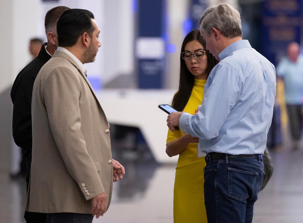 Airport director Jesse Romo, left, Wichita Mayor Lily Wu, middle, and Wichita city manager Bob Layton, right, gather at Wichita's Eisenhower Airport, Wednesday, Jan. 29, 2024, in Wichita, Kan., after news that an American Airlines flight from Wichita collided with a helicopter near Ronald Reagan National Airport. 