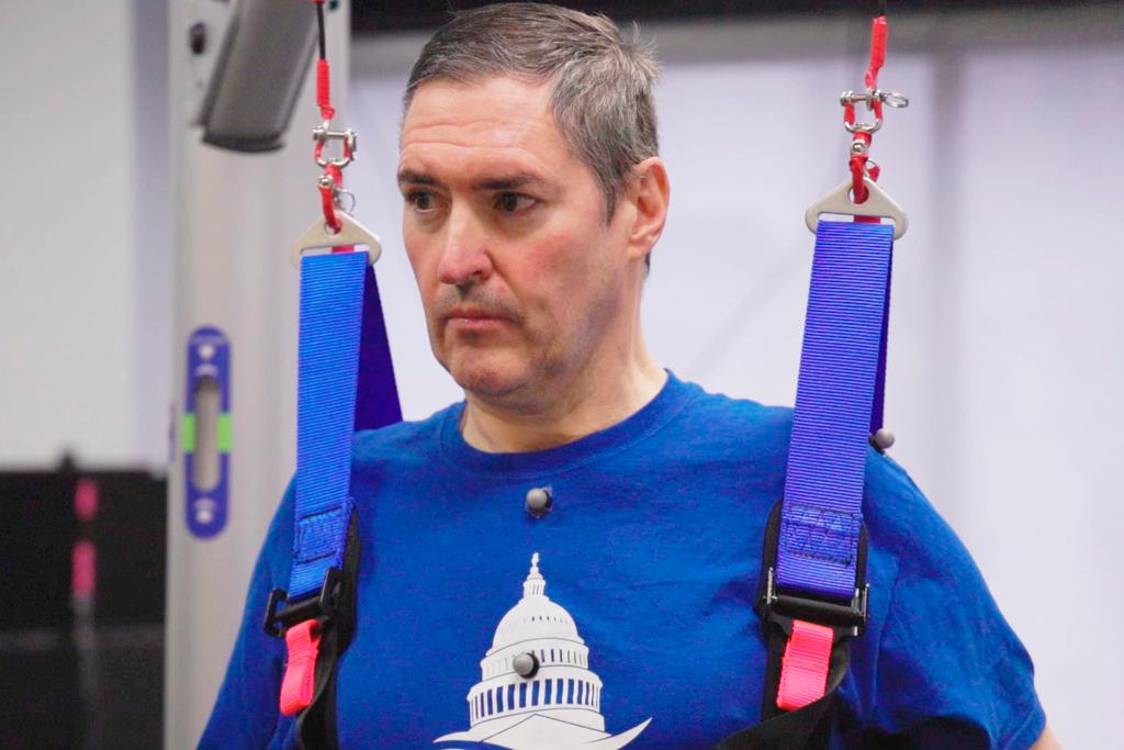 Doug McCullough, who has spinal muscular atrophy, during tests of experimental spinal cord stimulation to improve muscle function 