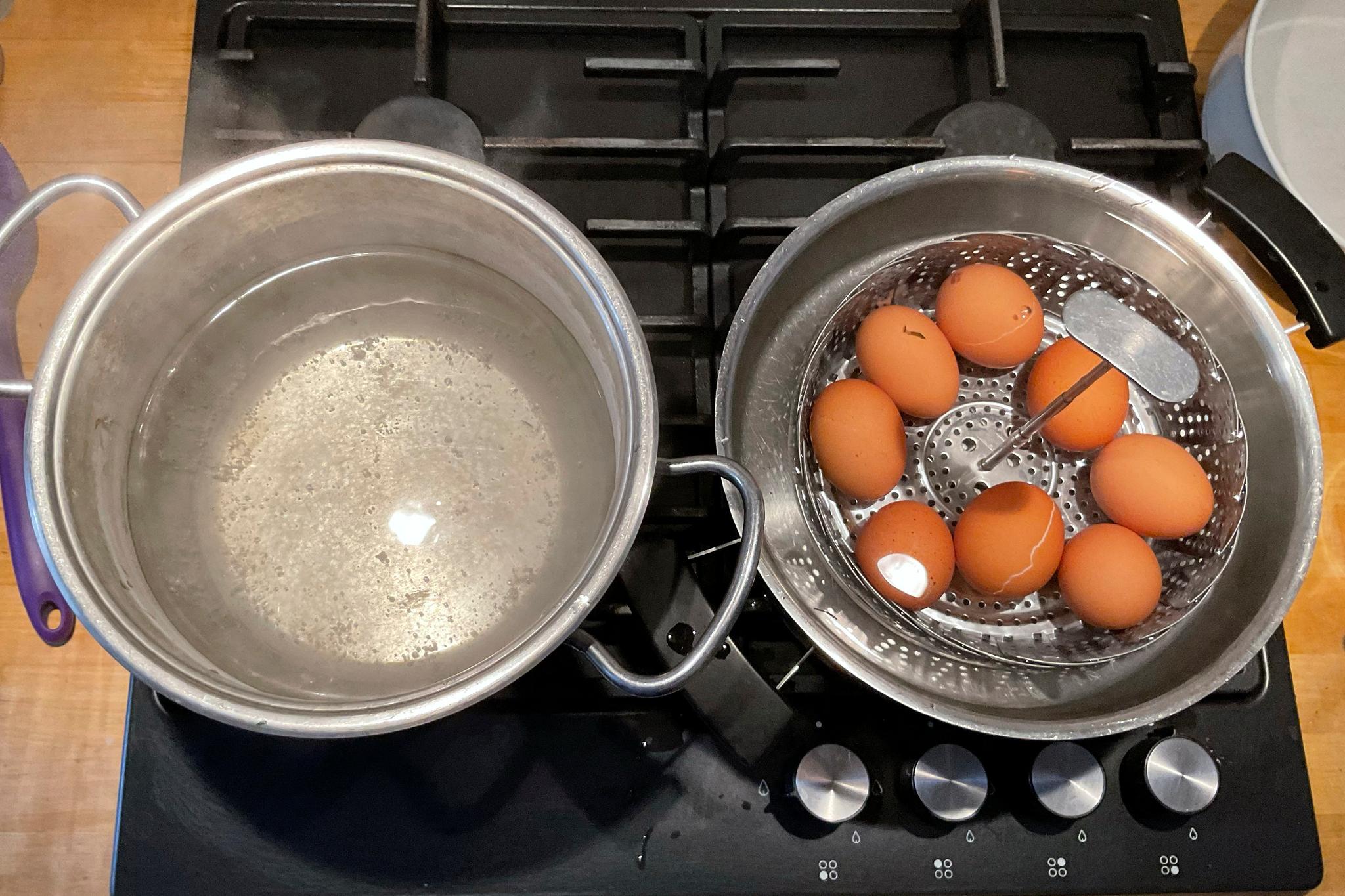 Two pans, one with hard-boiled eggs