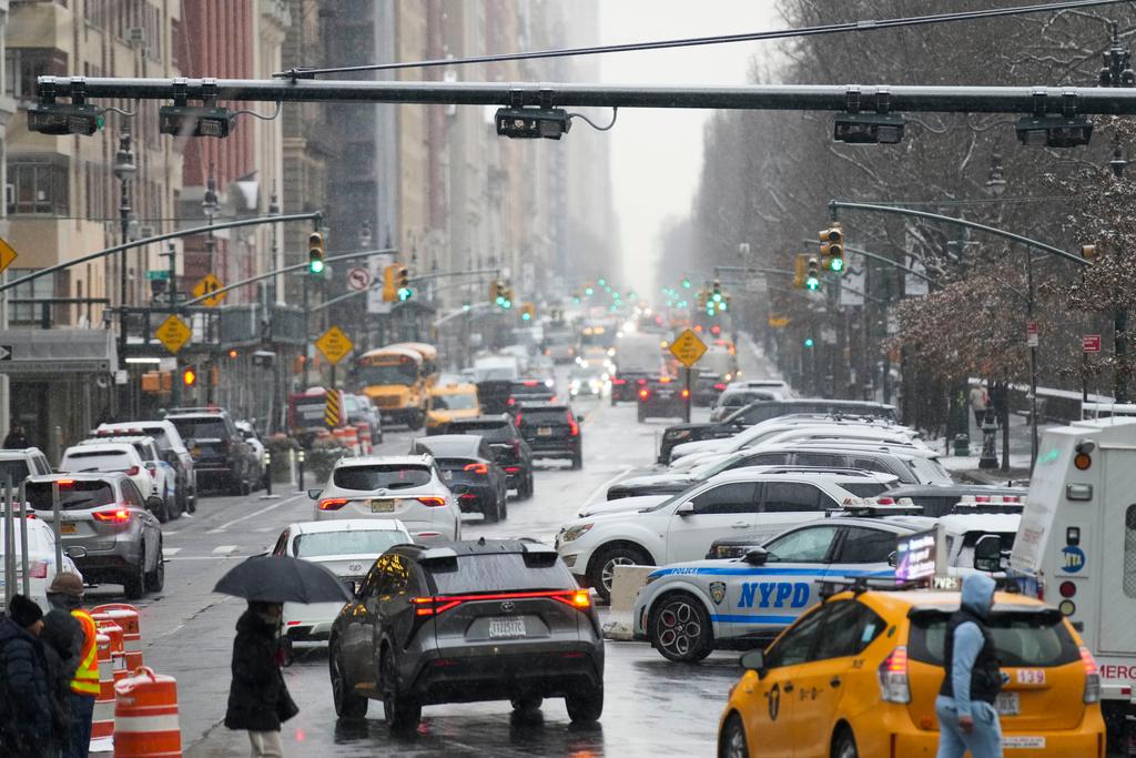 Devices used for congestion tolling hang above traffic on a Manhattan street in New York