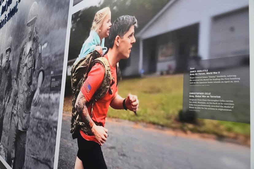 An image of Medal of Honor recipient Christopher Celiz jogging with his daughter, Shannon, in his backpack is on display at the National Medal of Honor Museum 